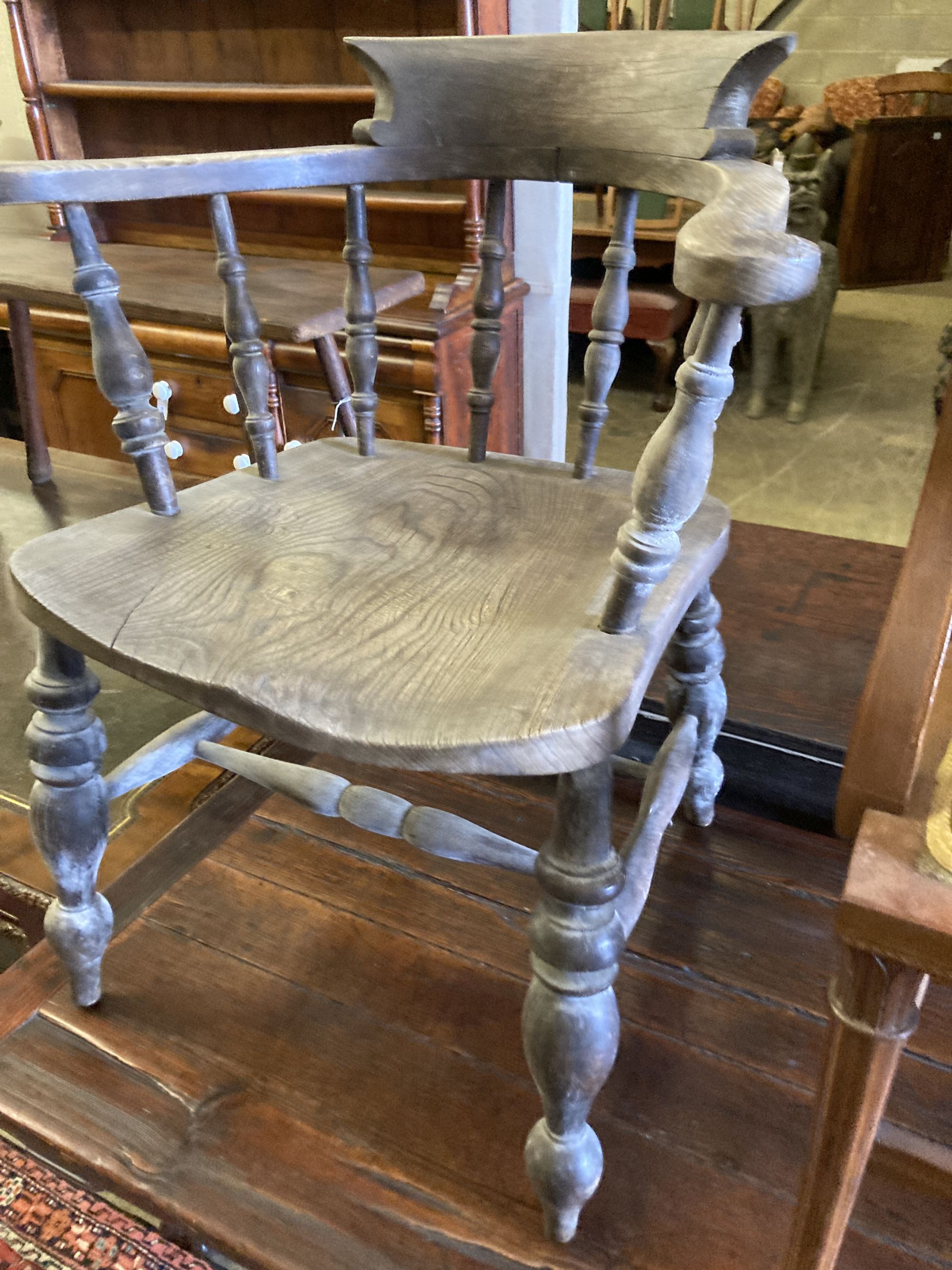 A Victorian bleached elm and ash smokers bow chair and an Edwardian inlaid mahogany elbow chair (2)